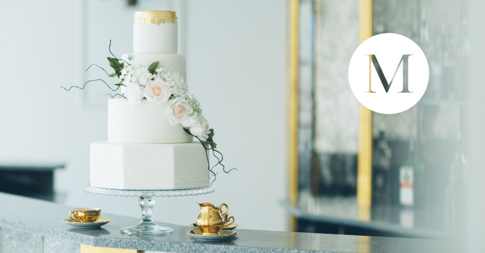 A photograph of a beautiful wedding cake, created by  Sharon McGowan.